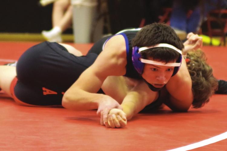 Arapahoe’s Titus Goshert earns a pin.