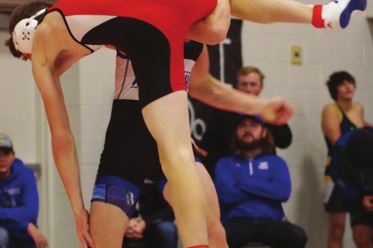 Arapahoe’s Tristian White uses a single leg for a takedown.