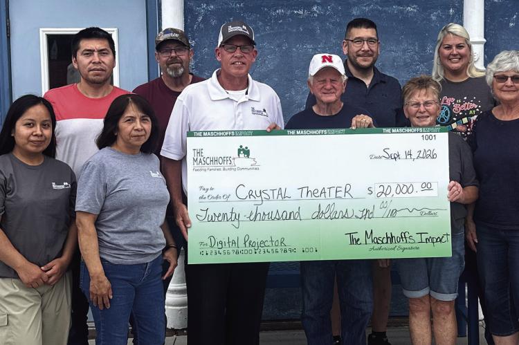Pictured at The Maschhoffs check presentation to the Crystal Theater are, front row left: Carmen Zamora Bernardino, Celia Martinez, Mike Harris, Don Sandel, Connie Hoefs, Linda Hamel and Bev Osiecki. Back row: Roger Hinz, Luis Javier Salomon Victoriano, Alejandro Canas Navarro, Harley Lambert, Erick Lee, Tiffany Downey and Ben Ellis.