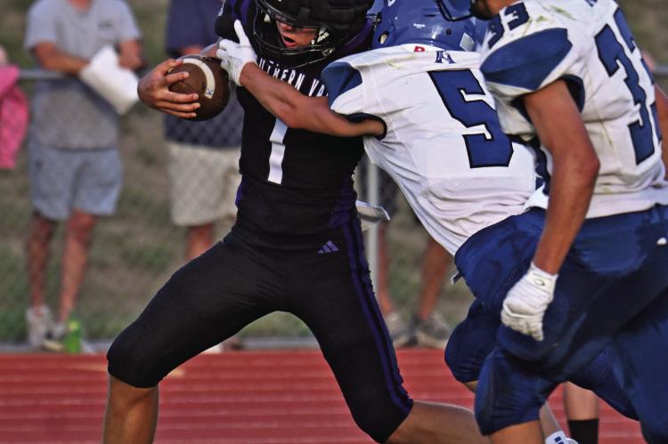 Southern Valley’s Hunter Lans runs through a tackle attempt.