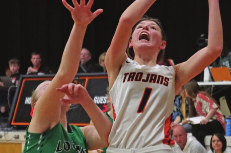 The Trojans’ Paige Klumpe powers up for a layup.