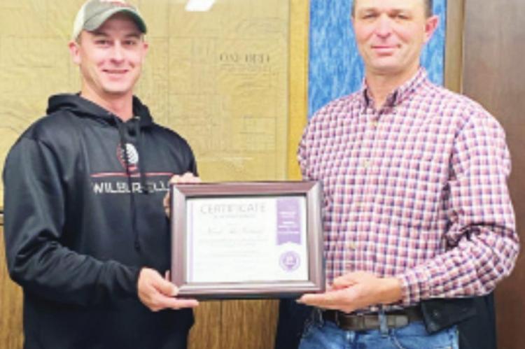 Oxford - Longtime Village of Oxford board chairman (pictured right) is presented a certificate of appreciation by Vice-Chairman Clint McQuiston for his 20 years of service.