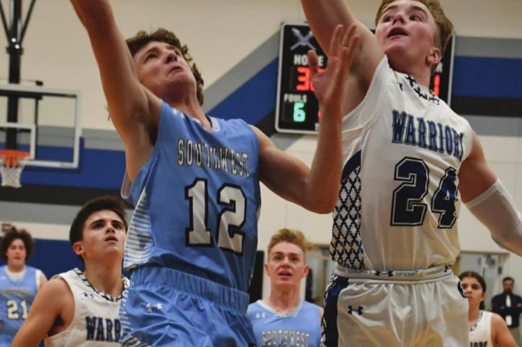 Southwest’s Trenton Williams goes in for a layup against Arapahoe’s Trenton Roskop.