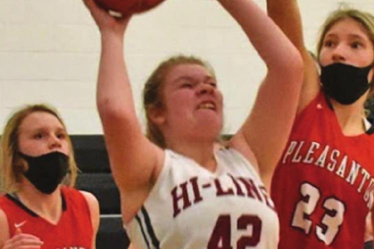 Hi-Line’s Gracie Gibbens attempts a baseline jumper.