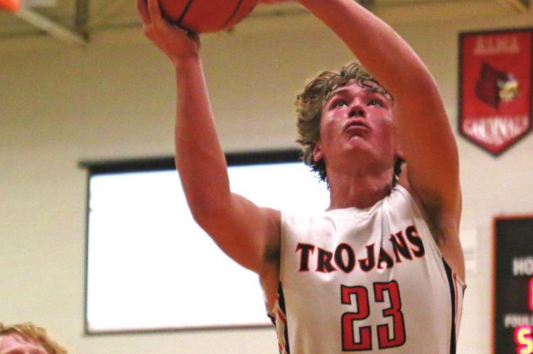 Cambridge’s CJ Fiene snares an offensive rebound before putting it back for a score.