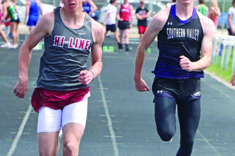Hi-Line’s Finn Kerznar and Southern Valley’s Tylor Grove approach the finish in the 100 prelims. Kerznar eventually finished third in the event.