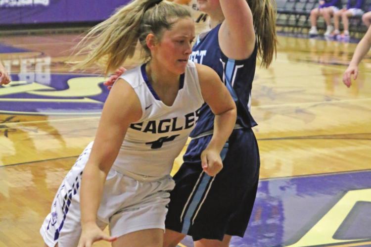 The Eagles’ Kynlee Marquez tries to drive around the defense of Southwest’s Haylee Adams.