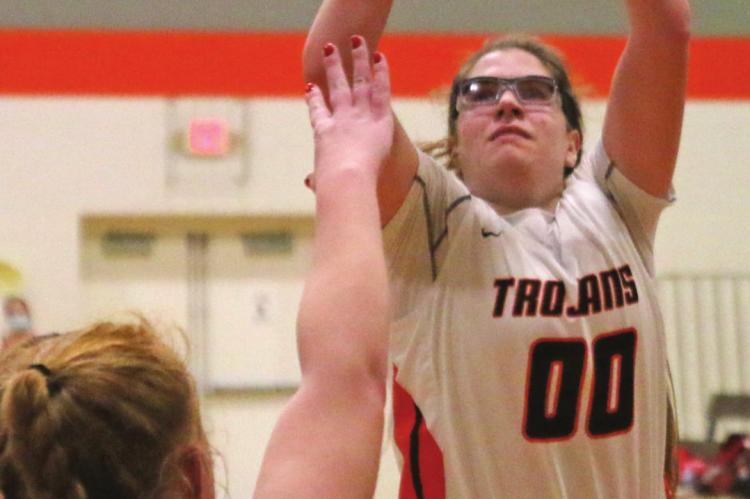 The Trojans’ Schyler Hoberty rises for a jumper in the lane.