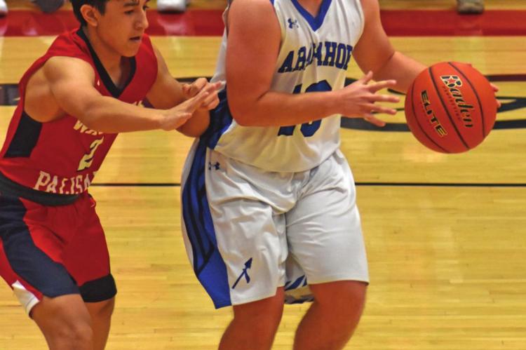 Arapahoe’s Cord Frink dribbles in the half court.