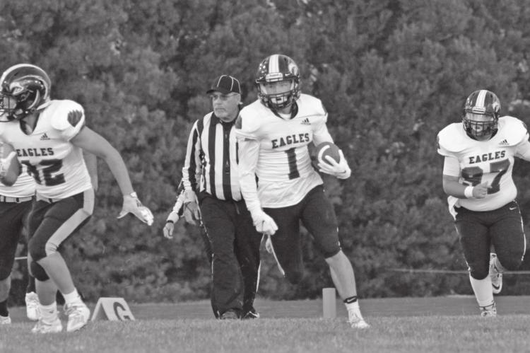 Southern Valley’s Brody Yant returns a kick at Bertrand with Dakota Coppedge and Isaak McPhillamy.