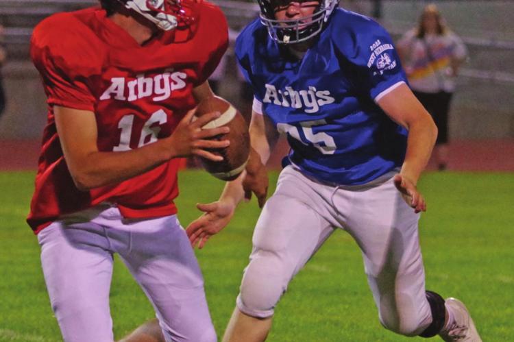 Hi-Line’s Carsen Reiners rushes the passer (above) and Arapahoe’[s Levi Kerner protects the passer (below).