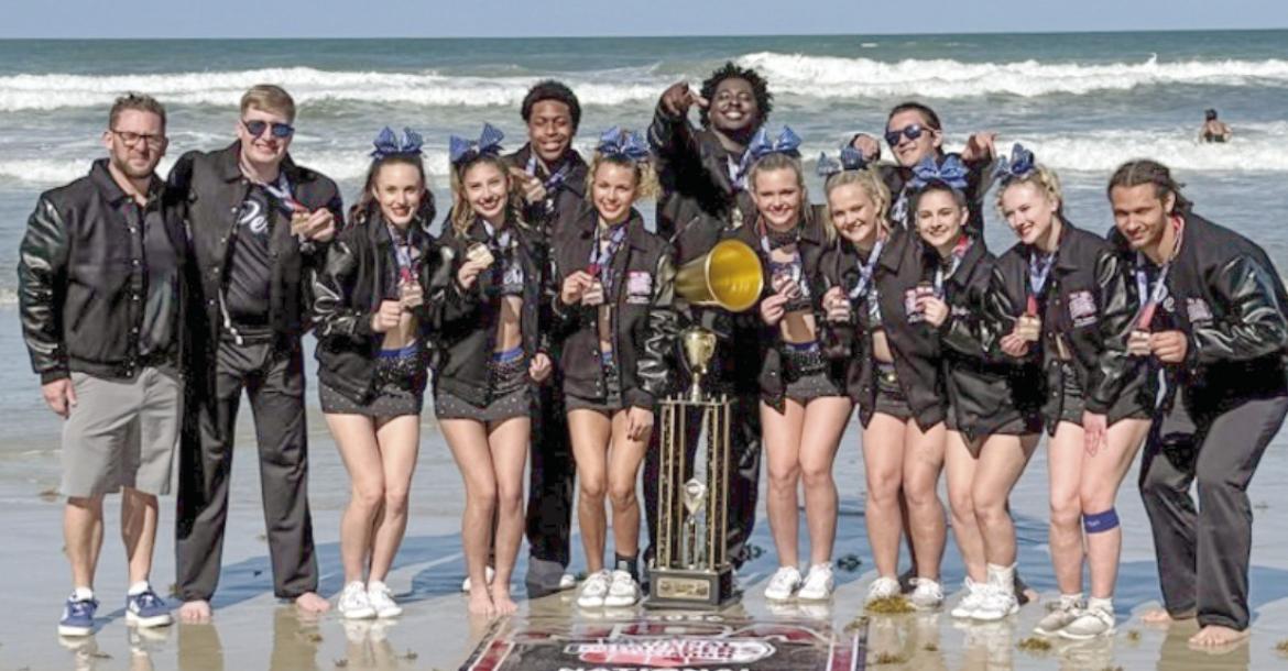 The Peru State competitive cheer team celebrated their national championship on the beach. In the photo (L to R): Interim Coach Joseph Gogus, Kohl Rutherford, Talia Case, Olivia Messer, Jeremy Porter, Nevaeh Wills, Gerald Lewis, Regan Wondercheck, Micaela Houseman, Daxx Bender, Sydney Cecil, Madison Eller, and Quinton Rowell.