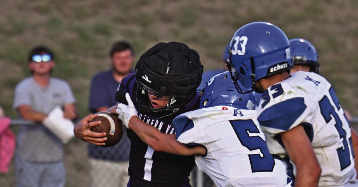Southern Valley’s Hunter Lans runs through a tackle attempt.